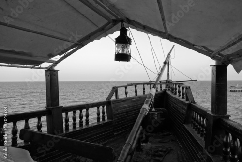 Old wooden vessel and sea view in black and white.