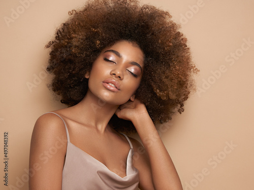 Beauty portrait of African American girl with afro hair. Beautiful black woman. Cosmetics, makeup and fashion photo