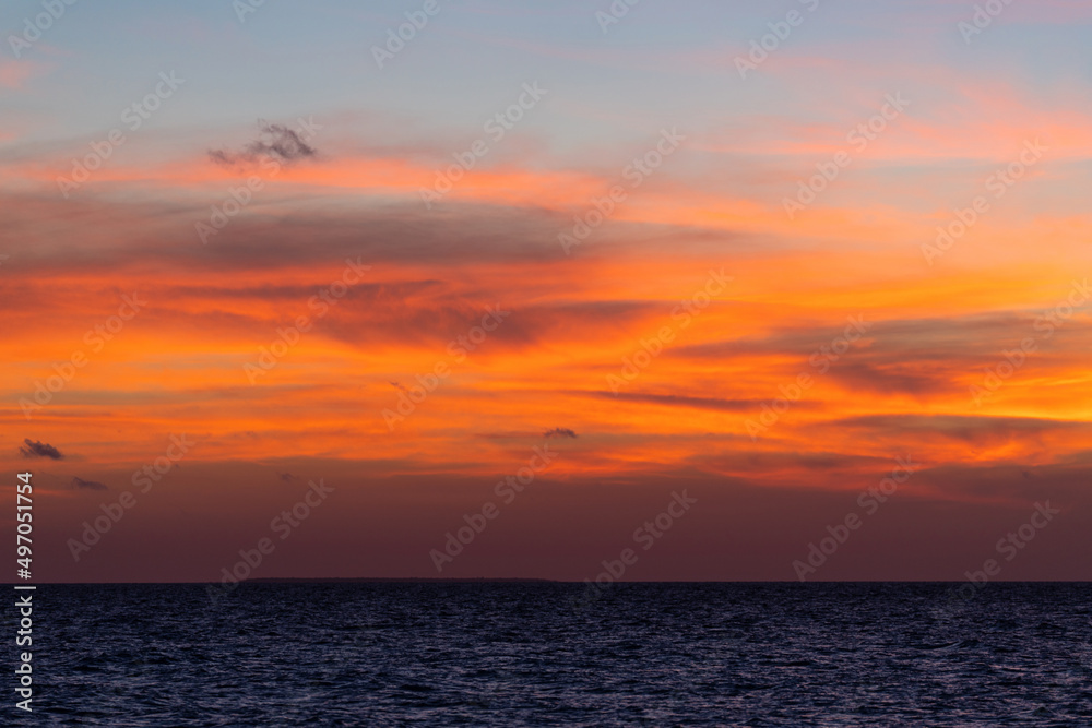 Beautiful view of the sea and the sky in the clouds at sunset. Orange red dawn, dusk on the sea coast