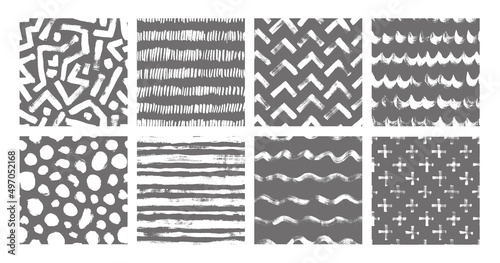 Set of vector geometric seamless pattern. Hand drawn grunge textures made with ink. Abstract background with brush strokes. Wavy lines, chevron, black dots, crosses and labyrinth. Ink brush scribbles.