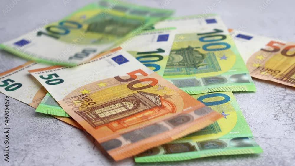 Money falling on table.Dropping lot of one hundred and fifty Euro paper banknotes on gray background Money falling on table.Dropping lot of one hundred and fifty Euro paper banknotes on gray background