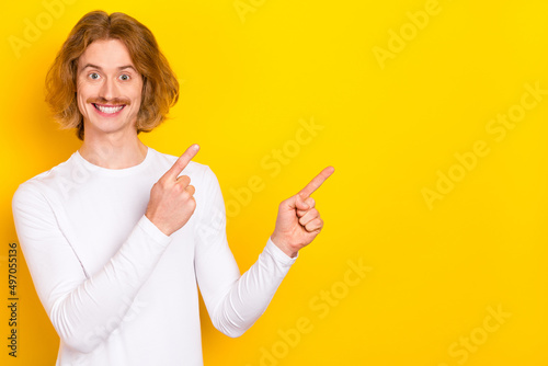 Photo of attractive sweet guy dressed white shirt pointing fingers empty space isolated yellow color background