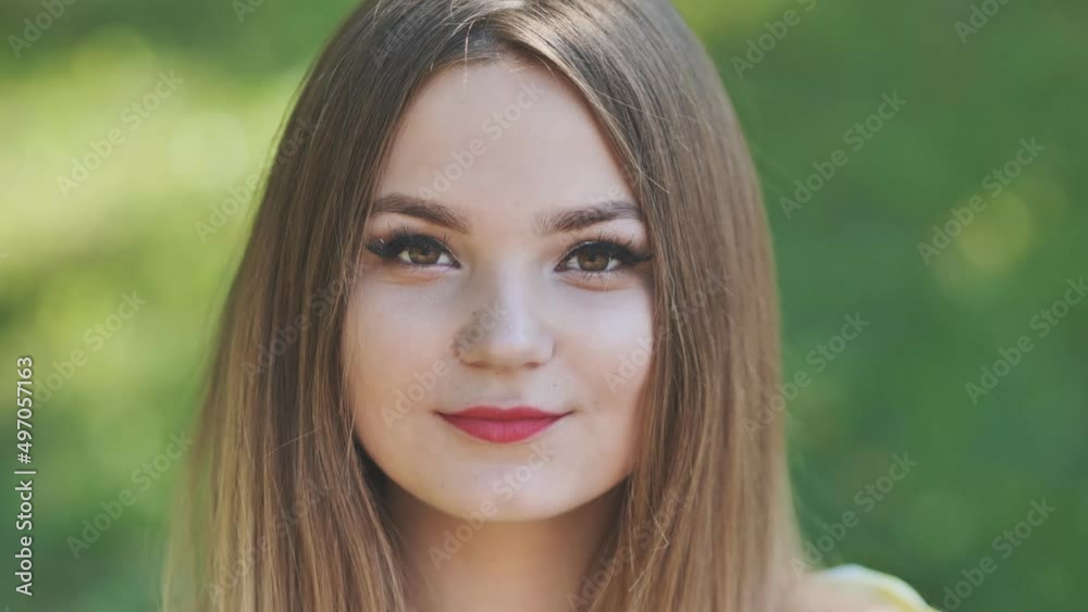 Portrait of a young girl in a park. Close-up of her face. Portrait of a young girl in a park. Close-up of her face.