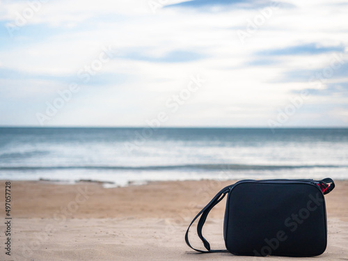 Bag on the beautiful beach blue ocean and sky background