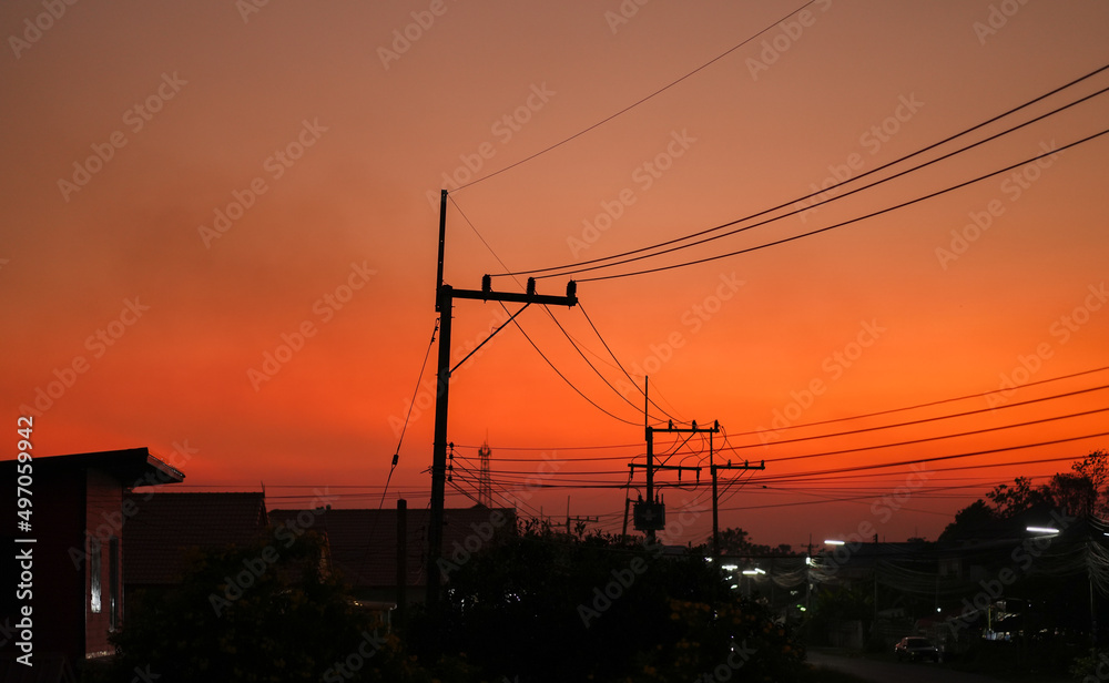 Community electric poles and the background is the evening sunset.