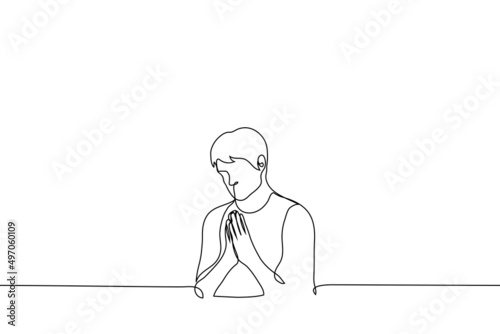 man put his palms together in supplication - one line drawing vector. the concept of praying or making a wish photo
