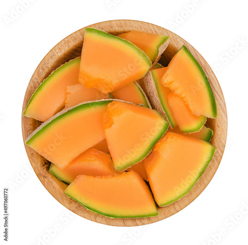 Cantaloupe melon pieces in wooden bowl isolated on white background with clipping path and full depth of field. Top view. Flat lay