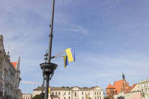 Ukrainian flags on the central square of the european city in Poland. Support and solidarity for Ukraine in the war.
