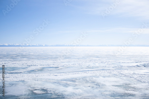 Winter landscape. Frozen lake. Blue sky. Background for postcards and banners.