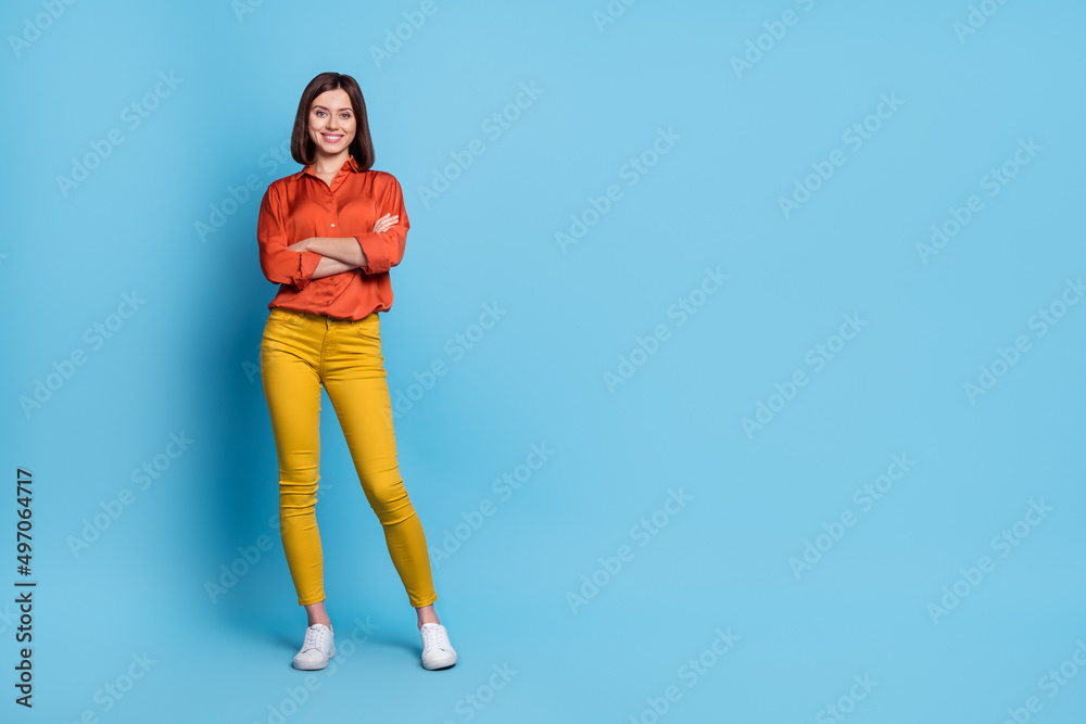 Full body photo of young pretty girl crossed hands smart employer promoter isolated over blue color background Full body photo of young pretty girl crossed hands smart employer promoter isolated over blue color background