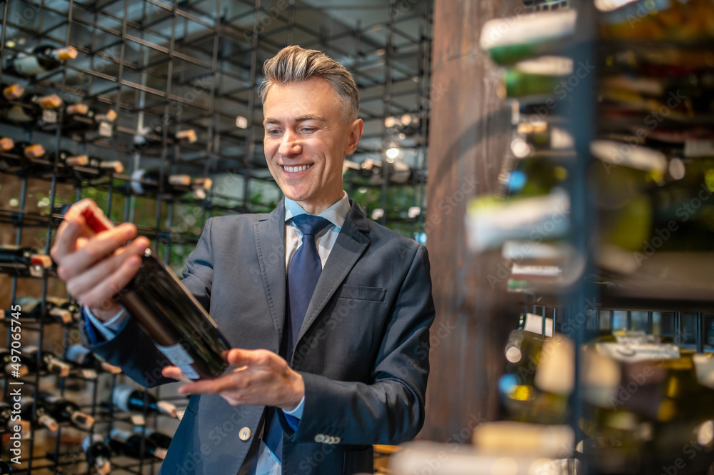 A male client choosing wina in a wine store