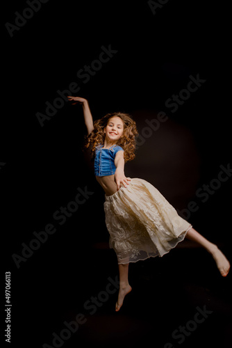 girl dressed in an outfit for dancing, on a black background