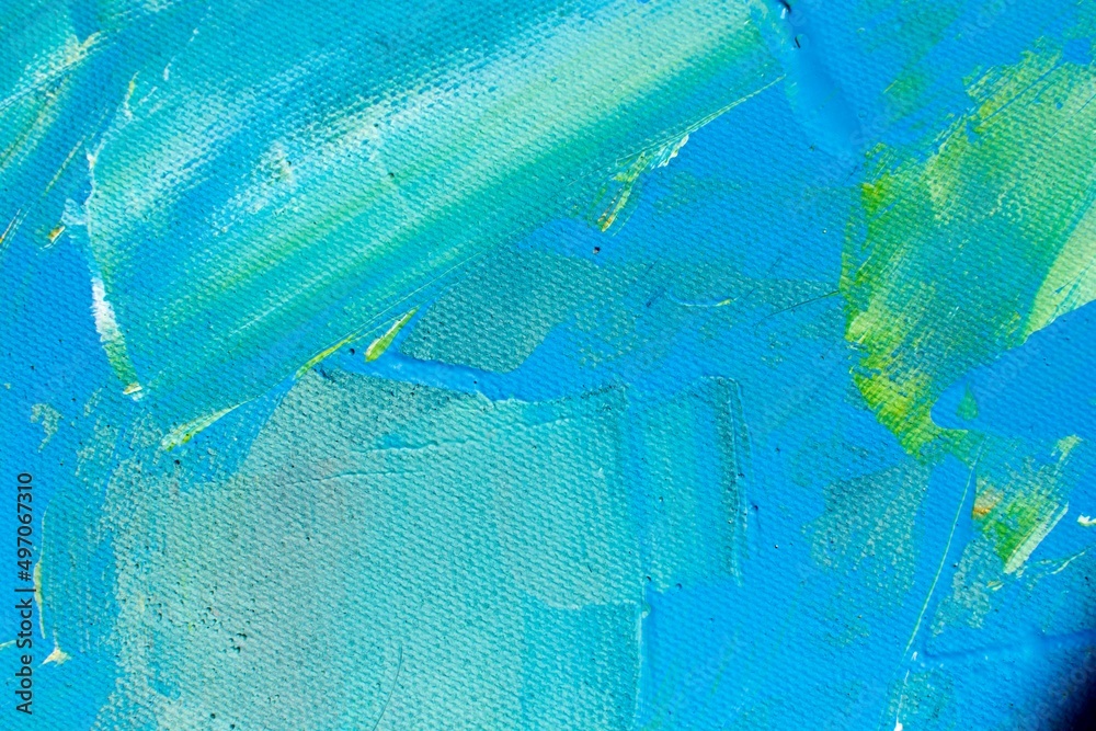 Acrylic blue background with natural canvas texture. Abstract watercolor blue pattern with green splashes. Oil painting with paint brush strokes close up for banner design. Environmental friendly.