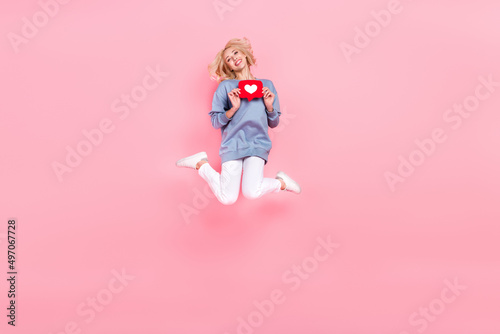 Full body photo of young cheerful girl have fun jump share repost app popular subscribe download isolated over pink color background
