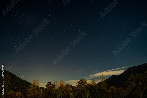 Starry night sky over the mountains in the landscape