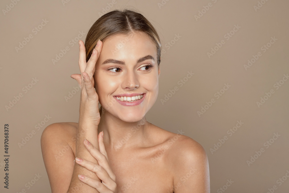 Beautiful Caucasian young woman with perfect skin touching face Beautiful Caucasian young woman with perfect skin touching face
