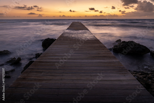Pier at sunset on a beach