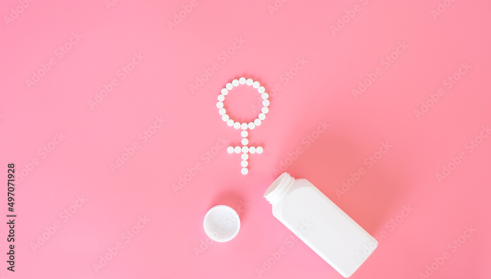 Pills on a pink background, flat lay, women's health.