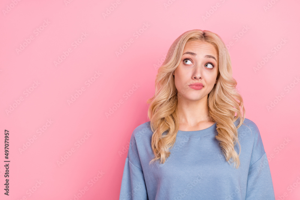 Photo of young lovely woman wonder think look empty space uncertain isolated over pink color background