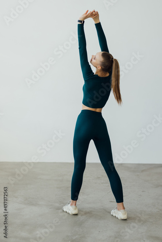 Portrait of a young woman stretching hands