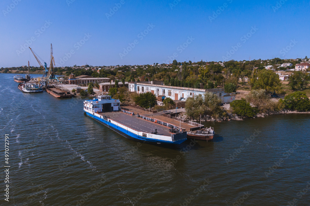 Nikopol river port from above. Photo of barges in the water.
Summer sunny day.