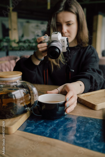 woman take photo of cup of tea. Selective focus
