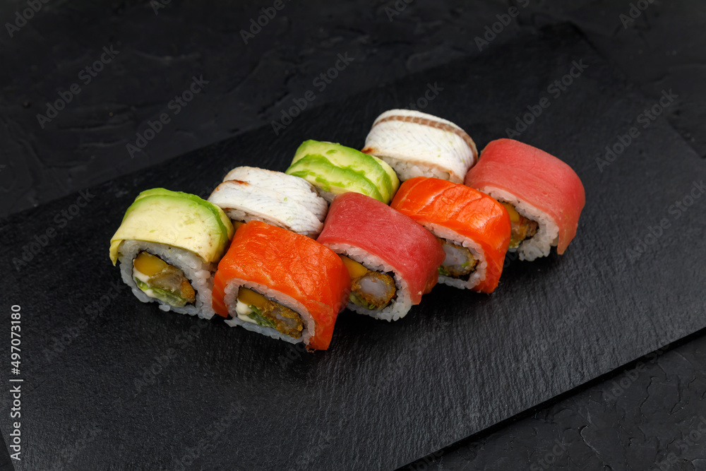 Japanese cuisine. Rolls on a dark concrete background
