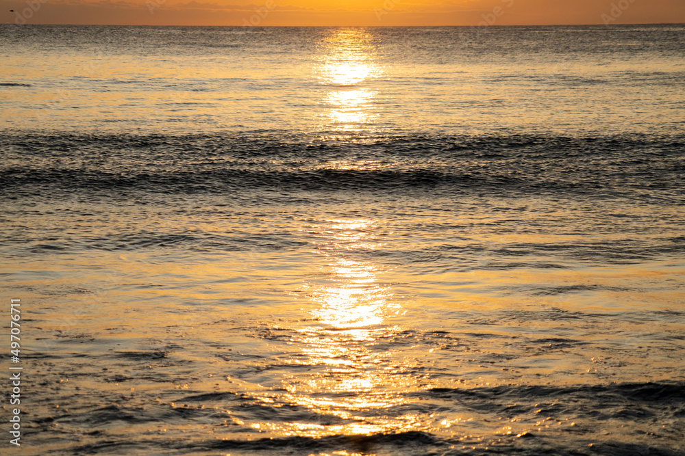 Wonderful orange sunset with birds on the beach in front of the sea. Arraial do Cabo, Rio de Janeiro, Brazil Wonderful orange sunset with birds on the beach in front of the sea. Arraial do Cabo, Rio de Janeiro, Brazil