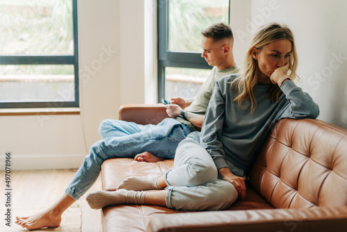 A young woman is sad and offended by her partner. Concept of problem in relationship photo