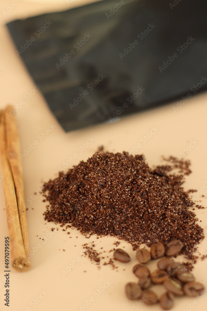 Home made texture scrub with cinnamon coffee and black pack on brown background. spa and home care concept, beauty procedures, vertical photo Home made texture scrub with cinnamon coffee and black pack on brown background. spa and home care concept, beauty procedures, vertical photo
