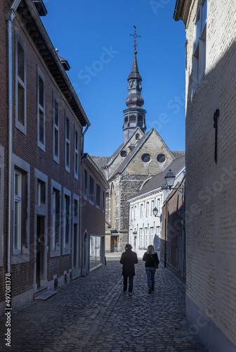 Tongeren. Belgium. Church. Street with pedestrians. Hikers.