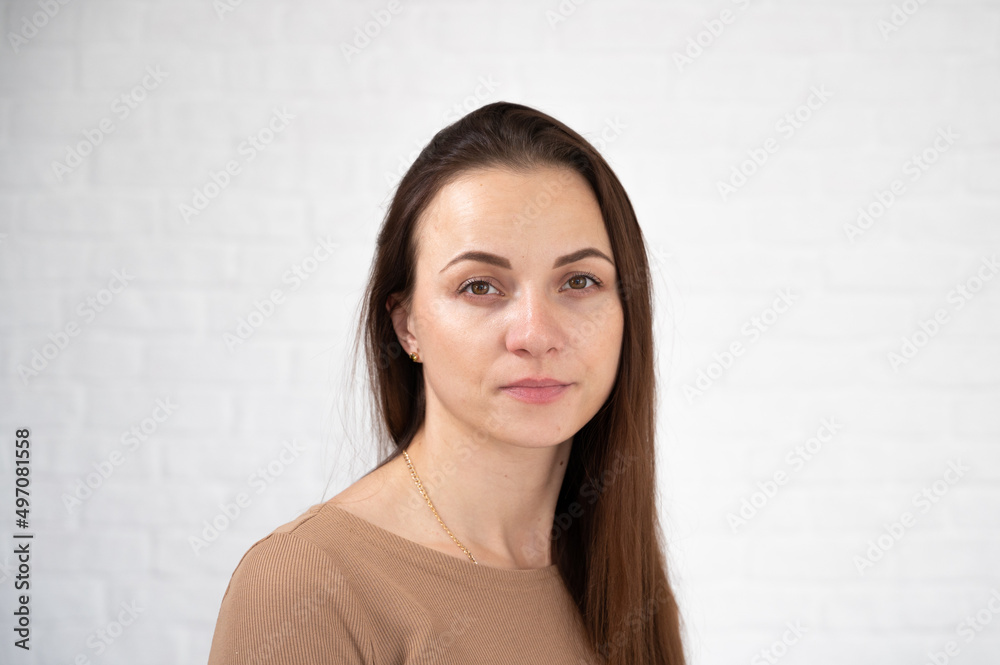 Portrait of young woman with poor eyesight isolated on white. Woman squints eyes and helps focus eyesight Portrait of young woman with poor eyesight isolated on white. Woman squints eyes and helps focus eyesight
