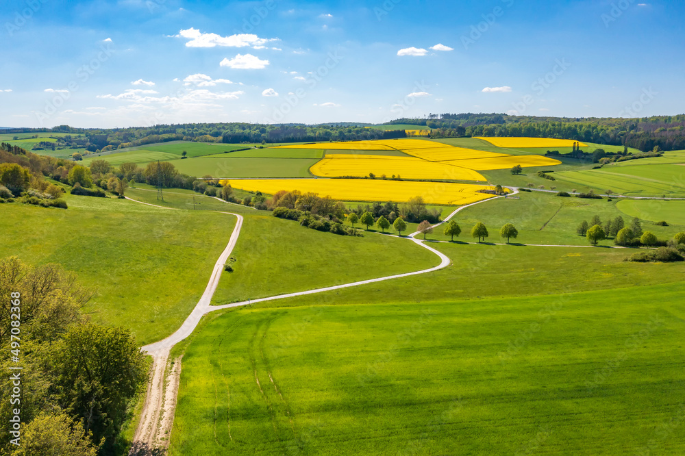 Fototapeta premium Bird's-eye view of a spring landscape in the Taunus/Germany with blooming rapeseed