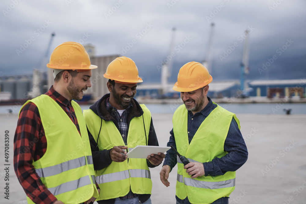 Multiracial men working at harbor for import and export transport Multiracial men working at harbor for import and export transport