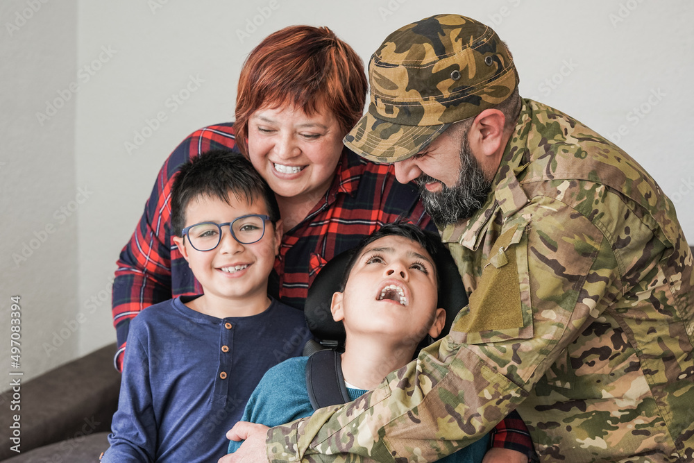 Military soldier being welcomed home by his family - Family love concept