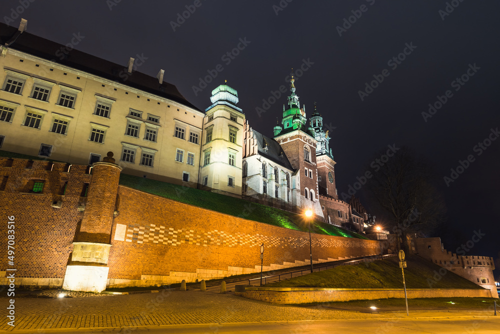 Wawel Royal Castle at night in Krakow, Poland. View from the Kanonicza street.