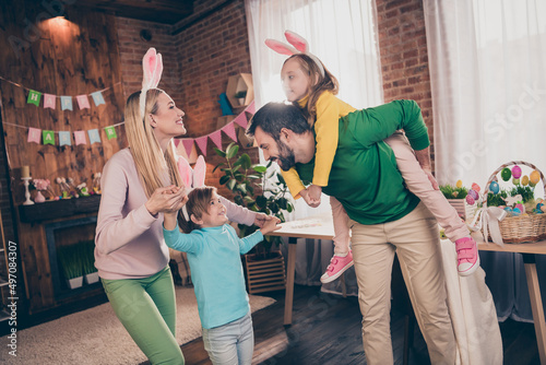 Photo of good mood funny family have fun together father hold piggyback his daughter playing with kids celebrate easter holiday
