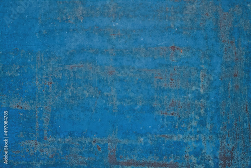 Old shabby painted blue metal surface background.