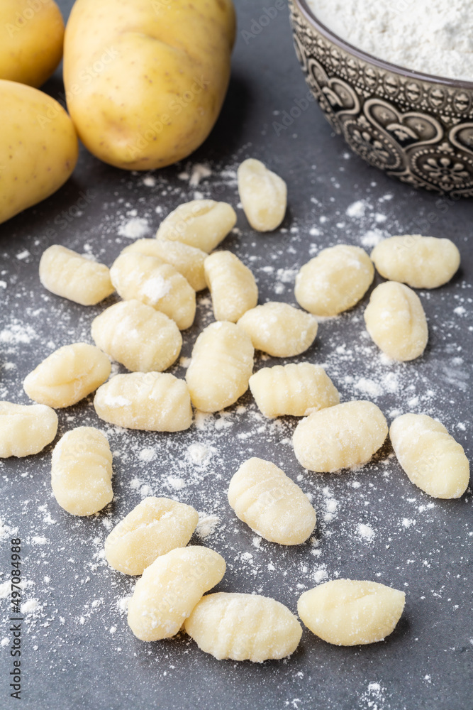 Uncooked italian pasta gnocchi over stone background Uncooked italian pasta gnocchi over stone background