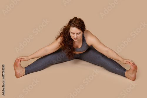 Fotografie Concentrated conscious motivated calm meditative overweight woman, gaining weight on lockdown COVID-19