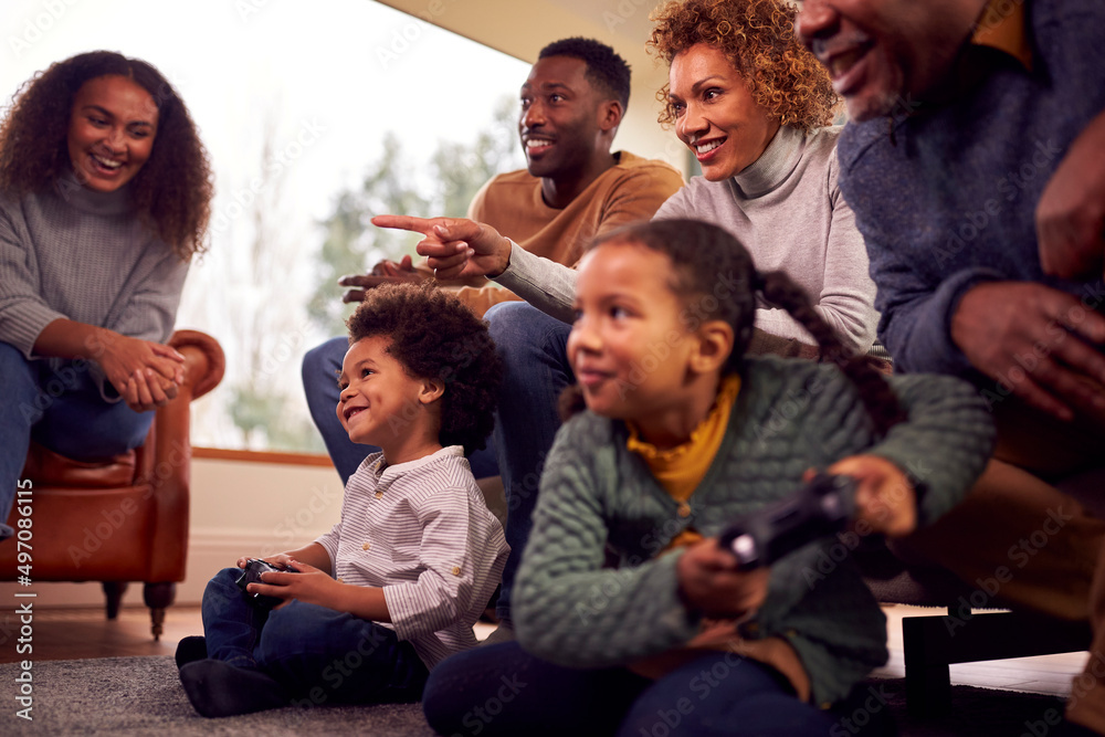 Fototapeta premium Multi-Generation Family Having Fun Playing Video Game In Lounge At Home Together