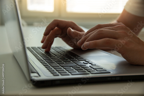 person typing on a laptop keyboard