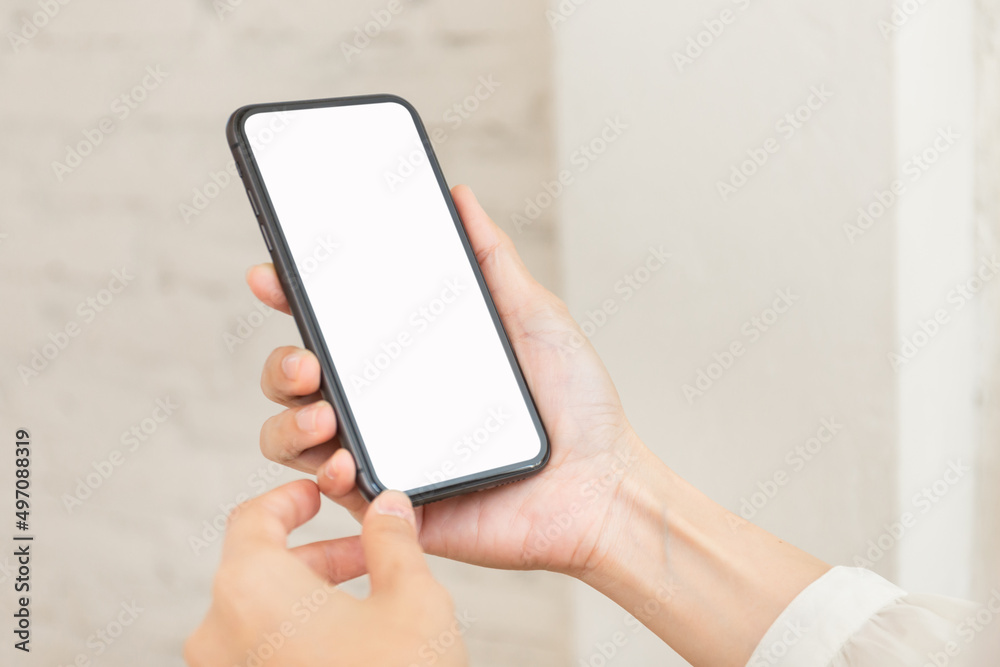 cell phone blank white screen mockup.hand holding texting using mobile on desk at office.background empty space for advertise.work people contact marketing business,technology cell phone blank white screen mockup.hand holding texting using mobile on desk at office.background empty space for advertise.work people contact marketing business,technology