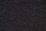 Black knitted fabric cotton textured background. Closeup with copy space for your design