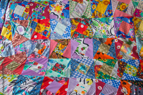 Background of Part of patchwork quilt with flower print. Handmade color blanket in style patchwork.