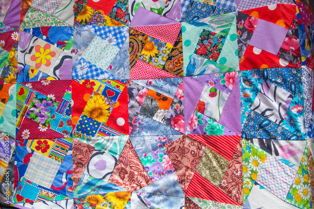 Background of Part of patchwork quilt with flower print. Handmade color blanket in style patchwork.