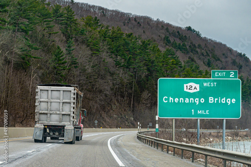 A large container truck passes us on Route 12A in Broome County in Upstate NY.  Red truck heading towards Chenango NY. photo