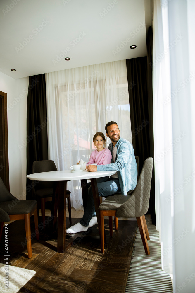 Father and daughter drinking tea together at the room Father and daughter drinking tea together at the room