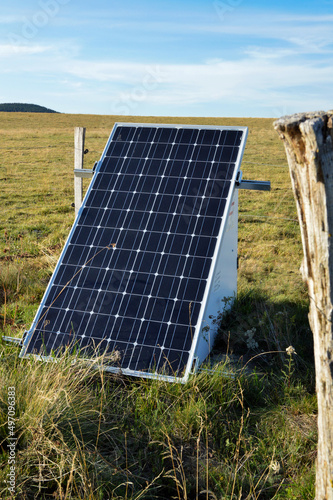 solar fence system with photovoltaic panels to power an electric fence.