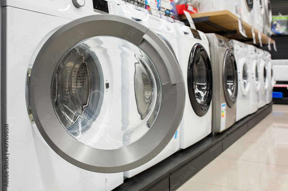 Open door of a washing machine in a household appliance store.